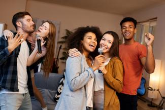 teens doing karaoke in living room 