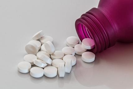 bottle of pills spilling over